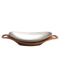 Strike a modern balance at your table with the Cradle serving bowl from Nambe's collection of serveware and serving dishes. Polished metal nests in a tray of sculpted wood, bringing the best of both materials to sleek, sophisticated decor. An elongated shape with built-in handles accommodates large entrees with ease and style.