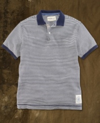 A preppy polo is transformed with weathered stripes and naval-inspired graphics for a vintage-inspired look that is ruggedly hip.