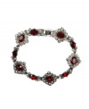 Regal bearing. Add a rich, resplendent finishing touch to your fall wardrobe with this elegant flex bracelet from Givenchy. Crafted in hematite tone mixed metal, it's embellished with red and black glass accents. Approximate length: 7-1/4 inches.