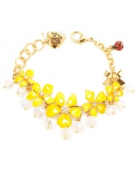 Warm up your look in hues inspired by the sun. Betsey Johnson's cheerful bracelet features bright yellow resin flowers with clear faceted beads and crystal accents. Set in gold-plated mixed metal with a red and black polka dot ladybug charm. Approximate length: 7-1/2 inches.