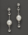 Bold sterling silver earrings set with freshwater pearls showcase Di MODOLO's unique Triadra cages.
