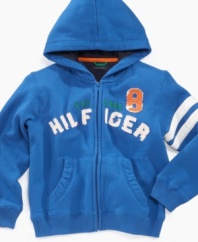 Bold blue color with varsity stripes on the sleeve of this Tommy Hilfiger hoodie get him ready for the game or anything else he might be doing.