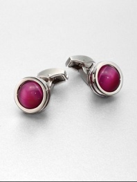 Round, rhodium-plated cufflinks with brightly colored glass inlay.Fiber optic glassAbout ½ diam.Made in the United Kingdom