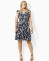 This dress boasts a V-neckline and crossover bodice with slight shirring at the empire waist.