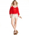 A skinny belt adds a splash of fun color to these chic, seamed shorts from BCX!