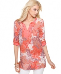 Calvin Klein Jeans' tunic is a beautiful burst of bright colors with its floral-inspired print and solid, coral-hued trim. Totally flawless when worn with skinny white jeans.