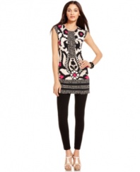 A sleek printed tunic from Alfani adds an element of contemporary chic to any wardrobe. Solid leggings and strappy sandals balance its bold pattern perfectly.