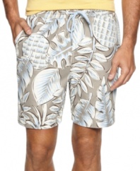 Made in the shade. Keep your cool in these stylish leaf-print swim trunks from Tommy Bahama.