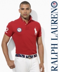 A trim-fitting short-sleeved polo shirt is rendered in breathable cotton mesh with bold country embroidery, celebrating Team USA's participation in the 2012 Olympics.