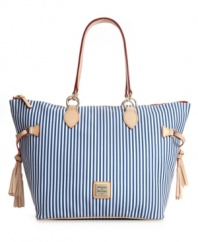 How sweet the stripes. A fun-loving striped shopper from Dooney & Bourke with playful tassel detail at sides and an iconic logo plaque at front.
