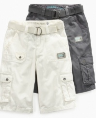 Easy going. Match his cool casual with these no-nonsense belted cargo shorts from Guess, a perfect pair for summer play.
