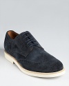 A relaxed but refined wingtip oxford rendered in soft suede.