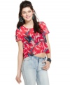 An assembly of dark bows overlay an open back on this crop top from Material Girl that's cool on the flip side, too!