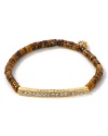 Follow your feline instincts and flaunt MICHAEL Michael Kors' tiger's eye bracelet--the fierce wristpiece lends exotic flair to staple tees or femme blouses.