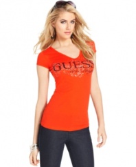 GUESS? makes jeans-and-a-tee look super sexy with this fitted top, featuring a bold hue and a graphic logo print at the bust.