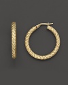 Bold, chunky gold hoops gain elegant distinction with an embossed basketweave pattern.