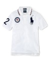 A preppy short-sleeved polo shirt in breathable cotton mesh is accented with London embroidery and a US Olympic Team embroidered emblem, celebrating Team USA's participation in the 2012 Olympics.