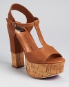 A glazed cork sole lends an unexpected touch to Dolce Vita's Baxter sandals, a T strap silhouette with girlish charm.