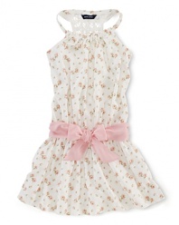 A summer charmer, this floral sleeveless dress finished with a crocheted racerback and a pretty pink sash is the perfect party dress for a June wedding.