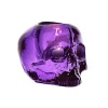 Designed by Ludvig Lofgren, this well-crafted glass skull makes a unique votive and its purple color shimmers under the flicker of a candle.