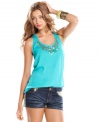 Tough studs and glimmering paillettes add embellished cool to a pretty tank top of tropical hue! From Eyeshadow.
