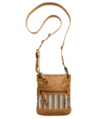 Stay organized and chic with a casual crossbody from The Sak. Silvertone accents and contrast stitching give this design both day and night-time appeal.