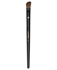 This angled, natural-bristled brush is the ideal partner to all eye shadows. Its slightly rounded edges perfectly apply shadow to the crease and corners of the eye. Brush hairs are slightly more narrow for controlled application. How to use: Dip the angled side of the brush into the shadow and tap off excess. For crease contouring press the angled side horizontally into the crease with the longer end toward the outside of the eye. For a bolder effect press vertically into the crease with the longer end downward. For corner contouring sweep the angled side downward from the outermost area of the crease, toward the lashes, finishing above the iris.