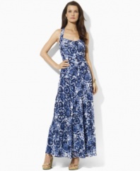 A breezy maxi dress from Lauren by Ralph Lauren is rendered in a bold print with a chic crossed back for a modern look.