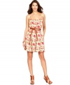 A pretty floral print adorns this Calvin Klein dress while a self-tie belt accentuates the silhouette!