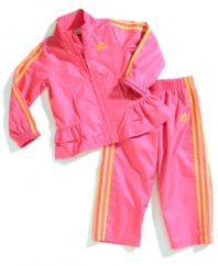 Ruffles and vibrant colors add girlie appeal to this sporty windbreaker jacket and pant set from adidas.