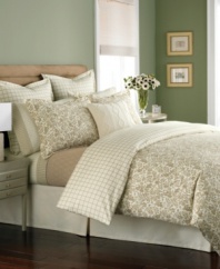Simply soothing. In a restful palette of tan and cream, this Wildwood Flannel duvet cover outfits the room in classic nature-inspired style, featuring a lovely winding floral design. Reverses to a plaid pattern.