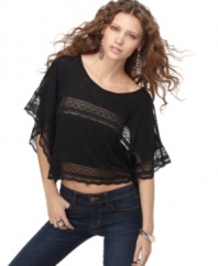 Lace trim adds feminine flair to this Free People cropped top in a relaxed shape perfect for a boho look!
