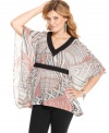 Jessica Simpson pairs a bold abstract print with poncho design on a top that adds optimal style to your day look!