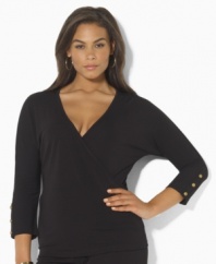 Slinky matte jersey creates a figure-flattering faux-wrap plus size design, tailored with three-quarter sleeves and anchor-embossed buttons for a hint of seaside chic, from Lauren by Ralph Lauren.