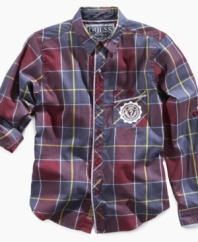 He can roll up his sleeves and get down to the business of looking good with this plaid shirt from Guess.