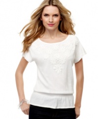 A tee with a refined touch, from Cable & Gauge. Lacy appliques in front and a peplum-style waist give this classic a feminine look.
