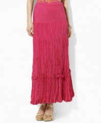 A cotton-silk maxi skirt is crafted in a crinkled silhouette for a unique breezy look.