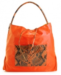 A casual nylon silhouette accented with a bold snakeskin print. This go-anywhere hobo will add a fiercely fun feel to any outfit. Bonus: this style is reversible!