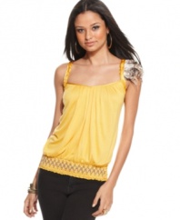 A removable feather pin adds tribal appeal to a tank top from Baby Phat that brightens your favorite jeans!