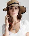 A packable woven cap with a ladylike bow and ribbon trim, a must-have accessory for your next holiday.