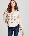 This Parker top masters bohemian luxe with vintage flair and femininity, flaunting colorful embroidery on a neutral silk silhouette. Enliven your wardrobe with the unique look and pair with retro denim styles.