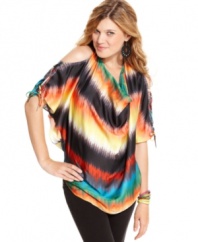 Exude rainbow magic in this oversized top from Jessica Simpson! Boasts a super colorful print -- plus chic cutouts that bare your shoulders and back.