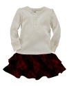 A comfy cotton ribbed Henley adorned with delicate lace along the neckline is paired with an adorable plaid ruffle skirt.