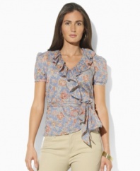 Light-as-air ruffles and a faded floral print lend vintage charm to Lauren Jeans Co.'s flattering wrap top in breezy woven cotton.
