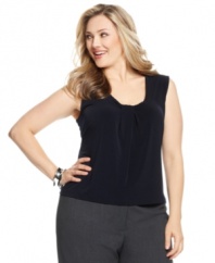 This plus size top is an essential made extra stylish with a twisted scoop neckline, ready to pair with your other style staples! By Calvin Klein.