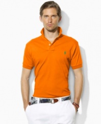 A classic short-sleeved polo shirt is cut for a relaxed, comfortable fit in smooth, soft cotton interlock.