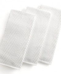 Grab style and keep function with a set of three kitchen towels that step forward in eye-catching color to wipe up spills, aid in prep and add an accent to your space. The textured design sets a sharp appearance for any room, while the highly absorbent terry quickly cleans up. Limited lifetime warranty.