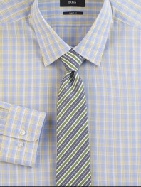A smart plaid in softened shades on pure cotton.Modified point collarButton frontBarrel cuffsCottonDry cleanImported
