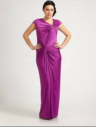 A bejeweled, floor-skimming satin gown that will turn heads this season. The gathered, twist-front bodice is especially flattering for curvy figures.Asymmetrical necklineCap sleevesJewel embellishmentGathered, twist-front bodiceConcealed back zipperAbout 46 from natural waist93% polyester/7% spandexDry cleanImported