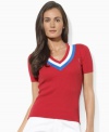 Preppy cricket stripes and an embroidered crest lend chic, athletic appeal to Lauren by Ralph Lauren's short-sleeved sweater, rendered in smooth ribbed-knit combed cotton for essential comfort and style.